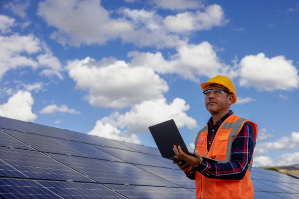 istock Male engineer working with a laptop on a field with solar panels 1796343928