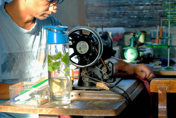 Tailor is using tumbler instead plastic bottle in daily job.