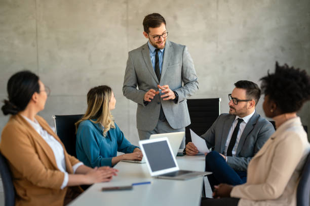 istock Multicultural professional businesspeople working together on research plan in boardroom. 1796366997
