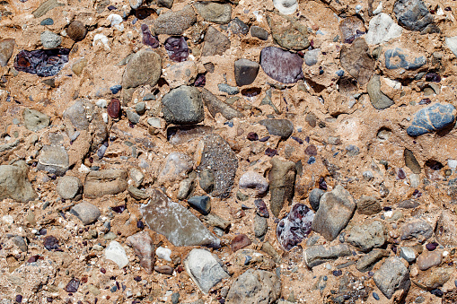 Sedimentary rock with inclusions of different minerals, close-up