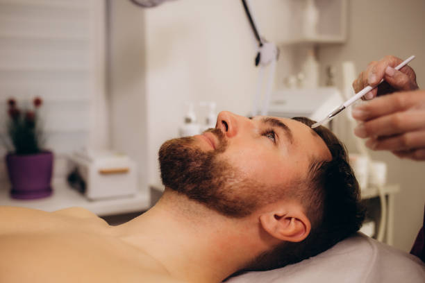 istock a beautician performs fractional mesotherapy on a man 1796371019