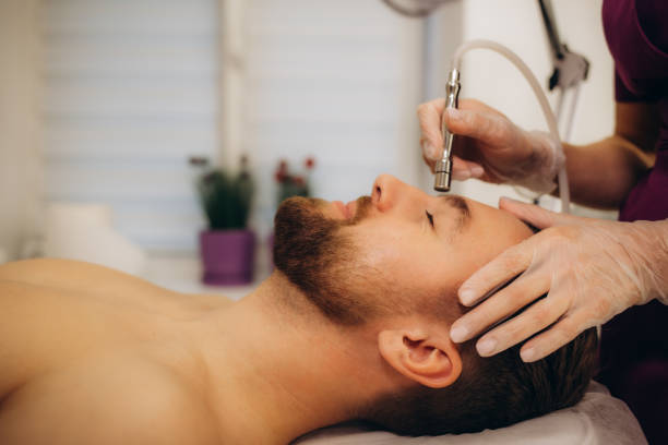 istock A man at a beautician undergoing a diamond microdermabrasion procedure 1796371021