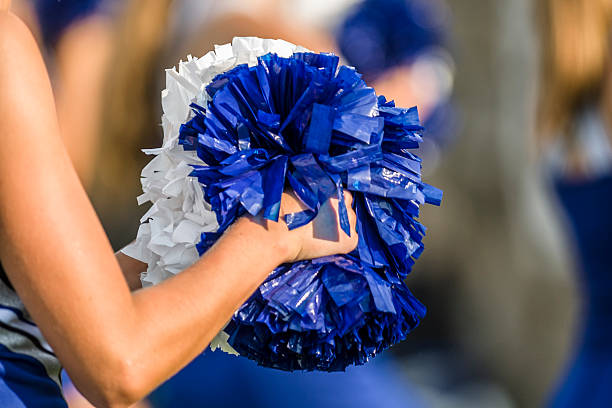 Cheerleader pom poms Cheerleader shaking blue and white pom poms cheerleader photos stock pictures, royalty-free photos & images
