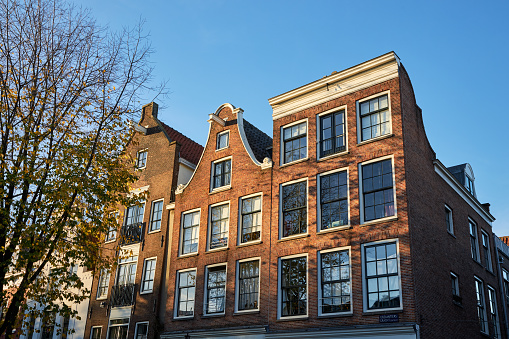 View of historic canal houses at sunset in Amsterdam, The Netherlands.