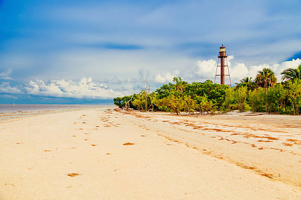 The Sanibel Island Light The Sanibel Island Lighthouse and beach. sanibel island stock pictures, royalty-free photos & images