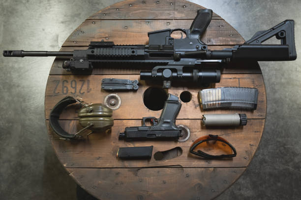 istock Tactical weapons at a shooting range. Pistol and rifle with optical sight and silencer. 1796404360