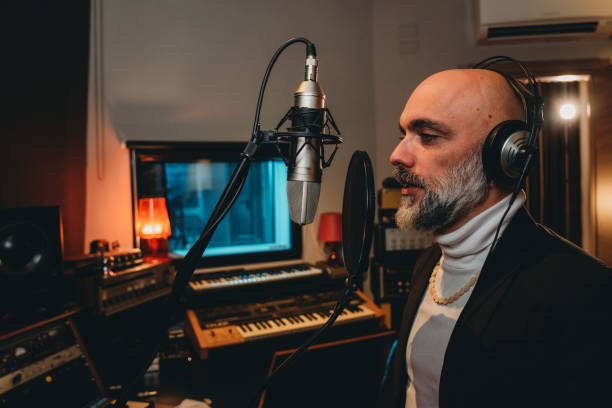 istock Singer is recording music in a professional recording studio 1796413191