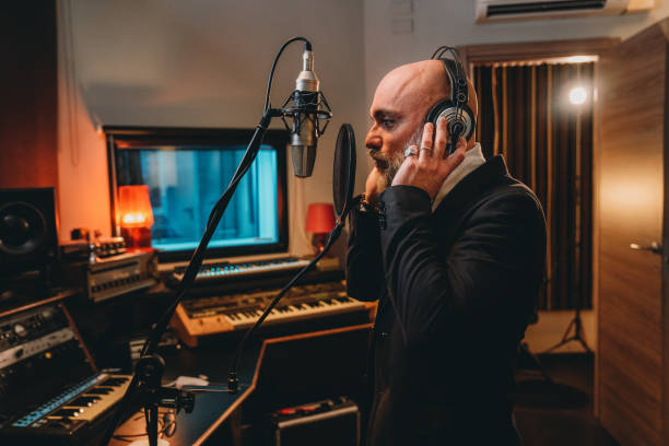 istock Singer is recording music in a professional recording studio 1796413710