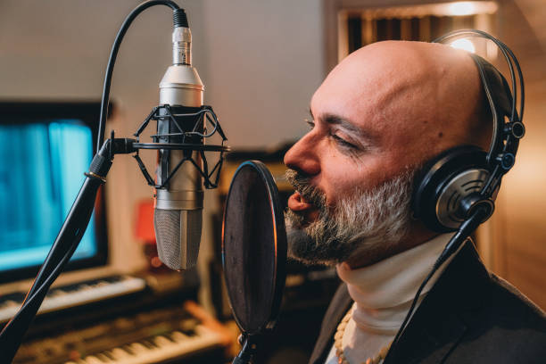 istock Singer is recording music in a professional recording studio 1796413720