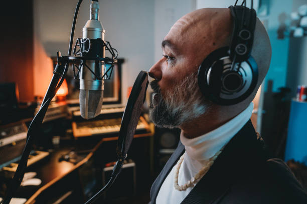 istock Singer is recording music in a professional recording studio 1796413740