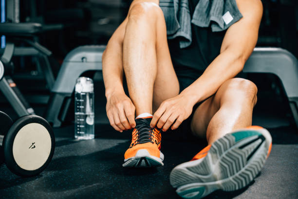 istock male athlete is tying his shoelace before a workout 1796419514