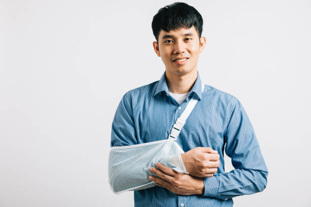 istock happy Asian man wears arm support in studio shot isolated 1796422331