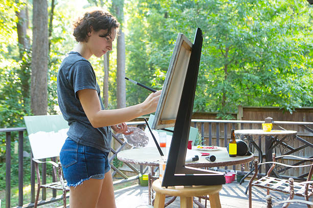 istock Young Woman Painting 179642344