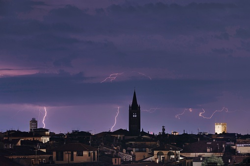 A dramatic weather scene of Verona, Italy with a brilliant display of lightning and thunder