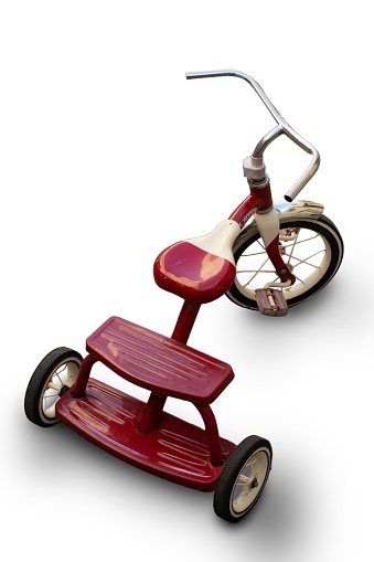 A closeup of a vintage red tricycle