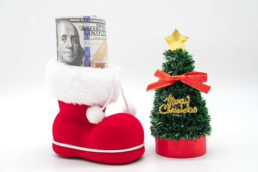 Dollars with boot of Santa Claus on white background. Merry Christmas and Happy New Year Concept. Xmas background. copy space.