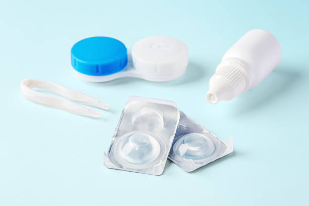 istock Contact lenses and accessories with eye drops on blue background 1796453759