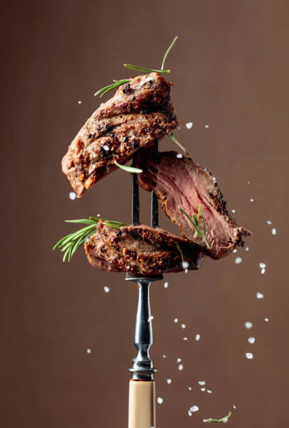 istock Grilled beef steak with rosemary on a brown background. 1796457063