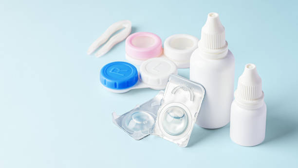 istock Contact lenses, solution bottle and eye drops with accessories on blue background 1796458171