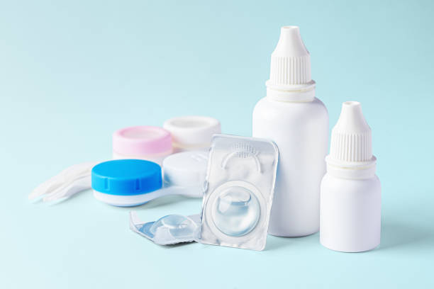istock Contact lenses, solution bottle and eye drops with cases on light blue background 1796458184