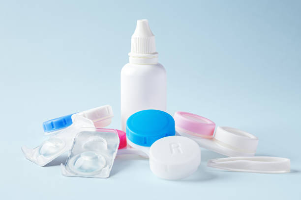 istock Contact lens solution bottle with contact lenses and cases on blue background 1796458723