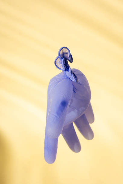 istock Frozen plastic glove against yellow background 1796463577
