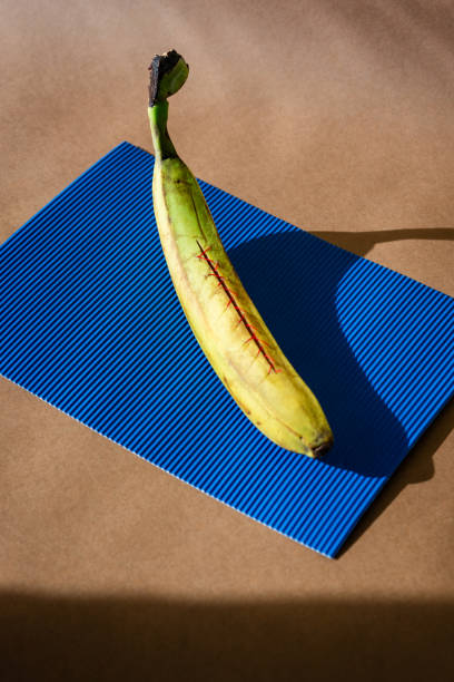 istock Rotten banana covered with thread against colored background 1796465201
