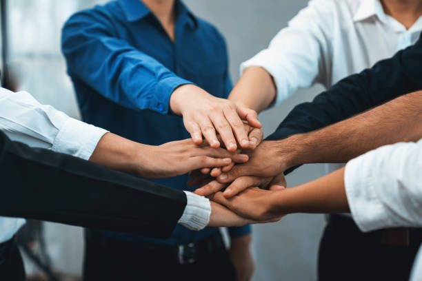 istock Group of diverse office worker join hand together in office. Prudent 1796472150