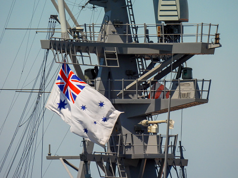 The communications mast of HMAS Sydney, a Hobart Class destroyer of the Royal Australian Navy.  She is docked at Garden Island naval base in Sydney Harbour.   This image was taken on a sunny afternoon on 11 November 2023.