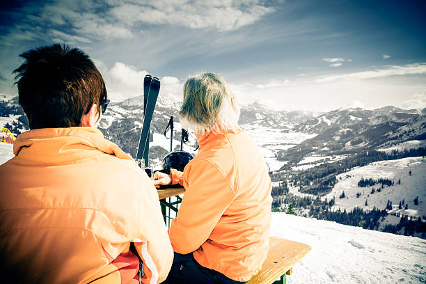 istock skiing senior couple having a break 179647815