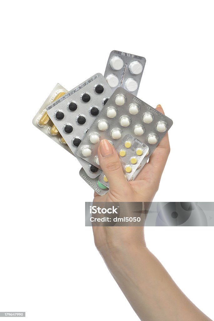 Manos sosteniendo paquetes de medicamento comprimido pastillas - Foto de stock de Asistencia sanitaria y medicina libre de derechos
