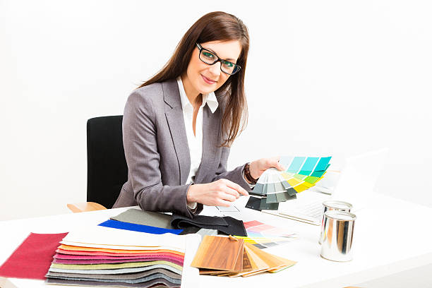 istock female interior designer at her desk 179648657