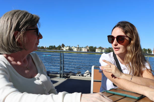 istock Ladies in conversation beside lake 1796491113