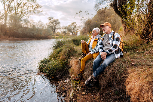 Senior couple enjoying their day near the river on sunny day