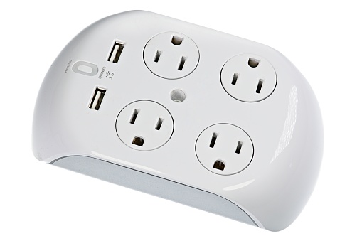 Unplugged electric appliance plug over switched off white power strip on the floor. Power crisis. Increasing the energy costs, heating costs, save electricity concepts. Power outage. Close-up.