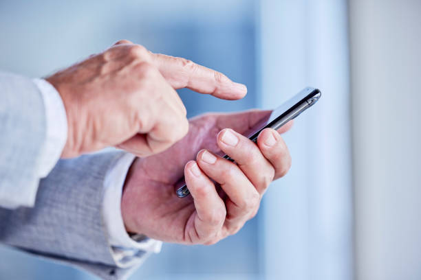 istock Hands, phone and scrolling with a business man in his office, closeup for communication or networking. Mobile, contact and internet with a male employee typing a text message or making a call 1796510232