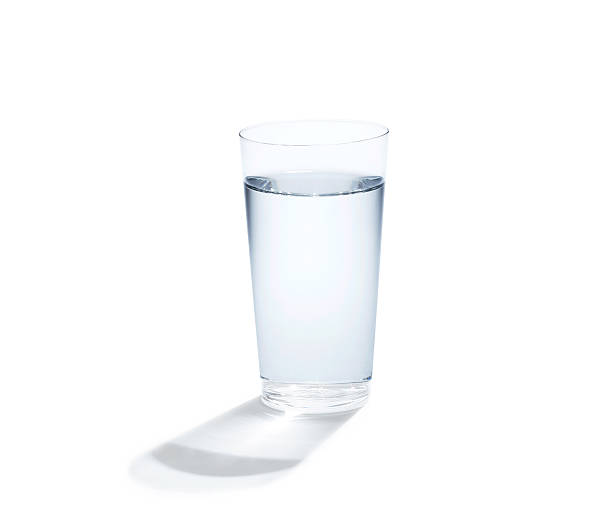 istock Tall glass of water throwing a shadow on a white surface 179651073