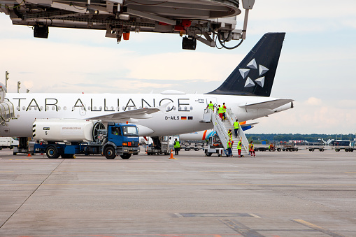 Passenger plane German airline STAR ALLIANS Airbus A-319 D-AILS. Airport apron workers. Maintenance refueling and interior cleaning. Airplane Lufthansa arrives. Ukraine, Kyiv - September 1, 2021.