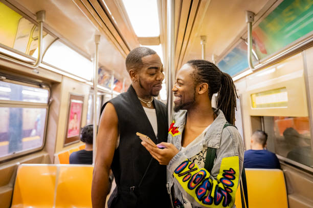 istock Mature gay man looking at young partner onboard A train 1796516766