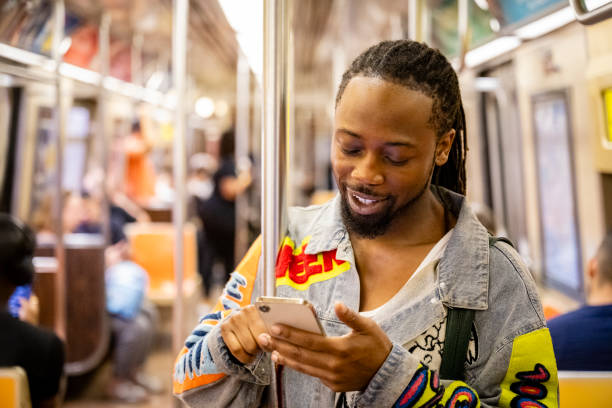 istock Young New Yorker riding A train and using smart phone 1796516967