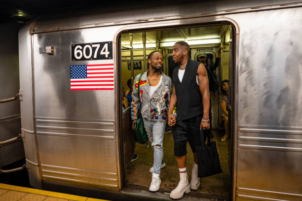 istock Gay couple disembarking subway train 1796517297