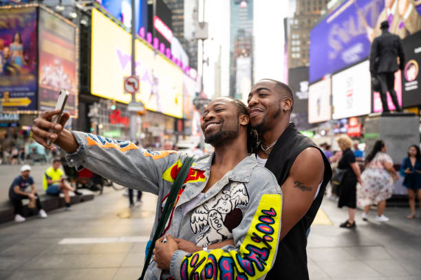 istock Black couple embracing while taking selfie in Times Square 1796517805