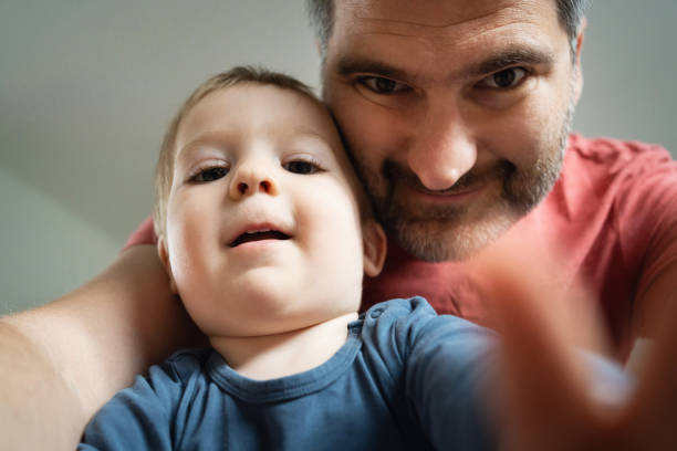 Adorable little boy playing with his father
