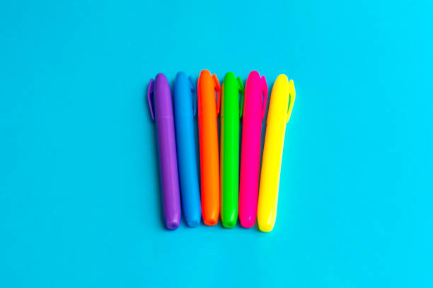 Multi colored highlighters at cyan blue background with copy space banner advertisement