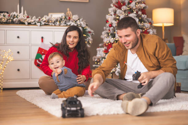 istock Parents playing with child while spending Christmas day at home 1796535699