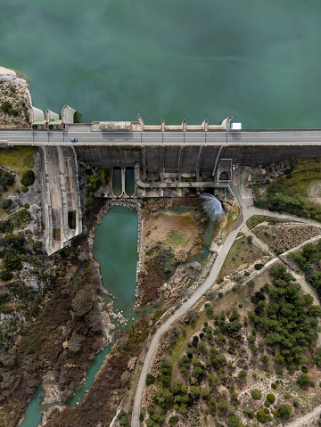 Wall of a gravity dam from above dedicated to irrigation and water containment and spillway channel in Bellus, in the province of Valencia, Spain. Civil engineering concept