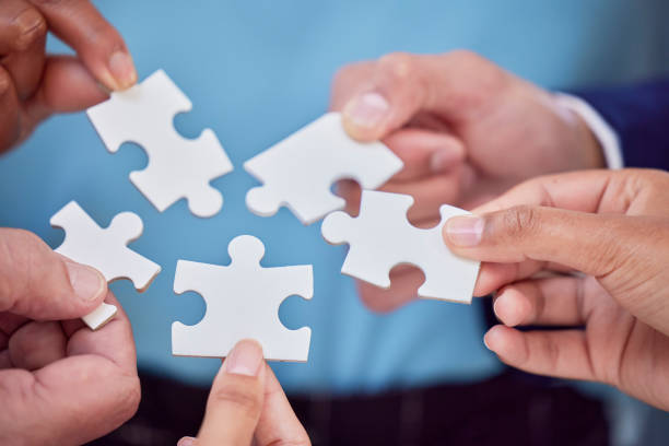 istock Hands, puzzle and team closeup of collaboration, creative and partnership, unity and cooperation. Zoom, hand and jigsaw formula by business people with synergy, teamwork and integration or strategy 1796543789