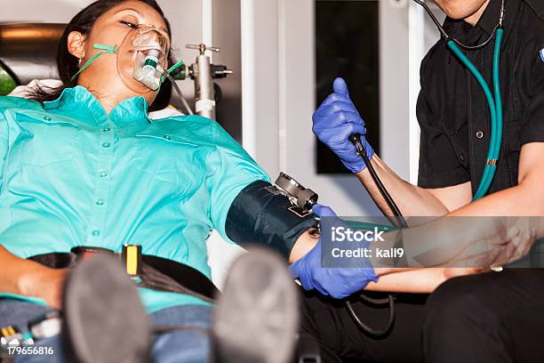 Paramedic With Patient On Stretcher Stock Photo - Download Image Now - Blood Pressure Gauge, Paramedic, 30-39 Years