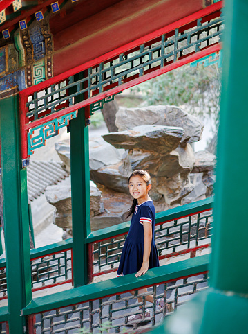 Little girl on steps of a Chinese  traditional corridor