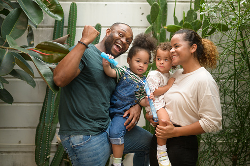 Portrait of Happy African American family enjoying gardening at home